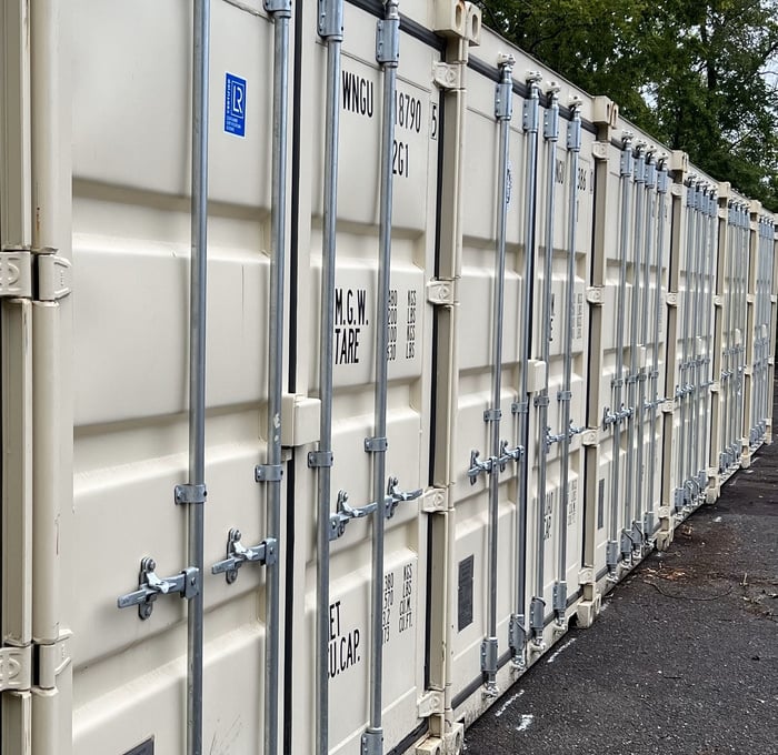 A row of light colored shipping containers at Container Land